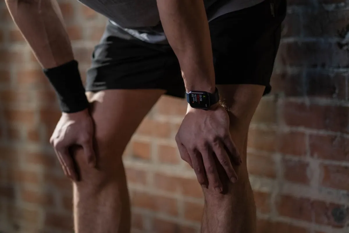 A smart watch showing workout figures on the wrist of someone resting after exercise